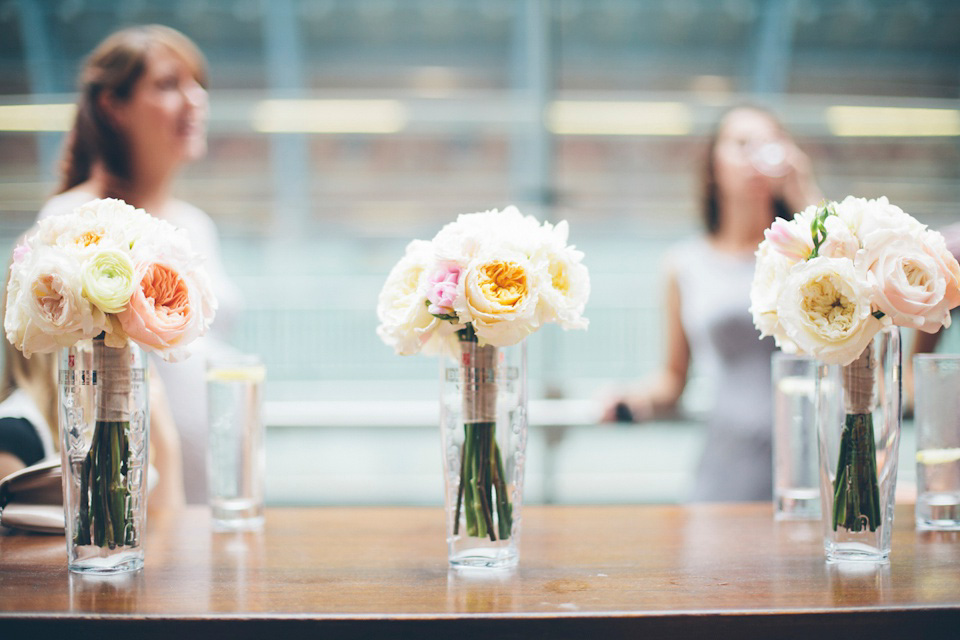 The bride wears a Belle & Bunty gown in blush for her child and family friendly wedding at Trinity Buoy Wharf in London. Photography by Kat Green.