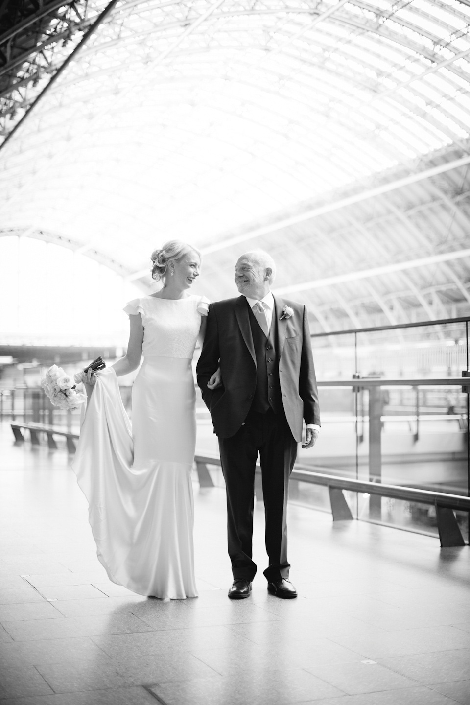 The bride wears a Belle & Bunty gown in blush for her child and family friendly wedding at Trinity Buoy Wharf in London. Photography by Kat Green.