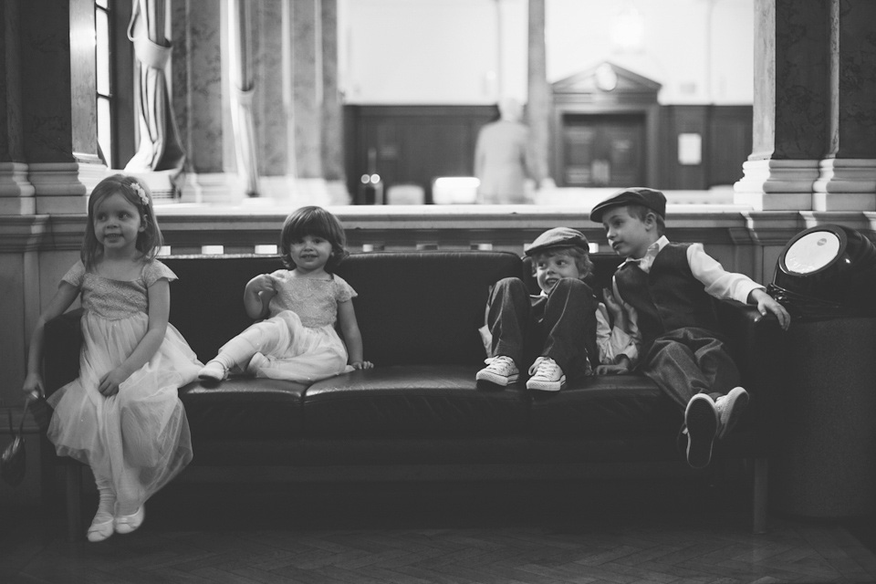 The bride wears a Belle & Bunty gown in blush for her child and family friendly wedding at Trinity Buoy Wharf in London. Photography by Kat Green.