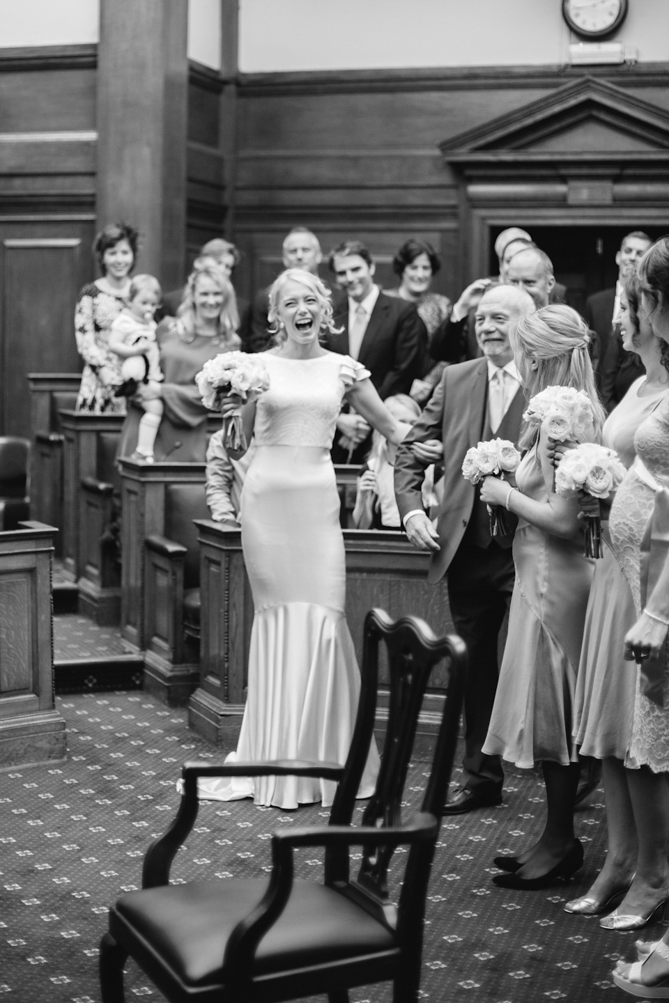 The bride wears a Belle & Bunty gown in blush for her child and family friendly wedding at Trinity Buoy Wharf in London. Photography by Kat Green.