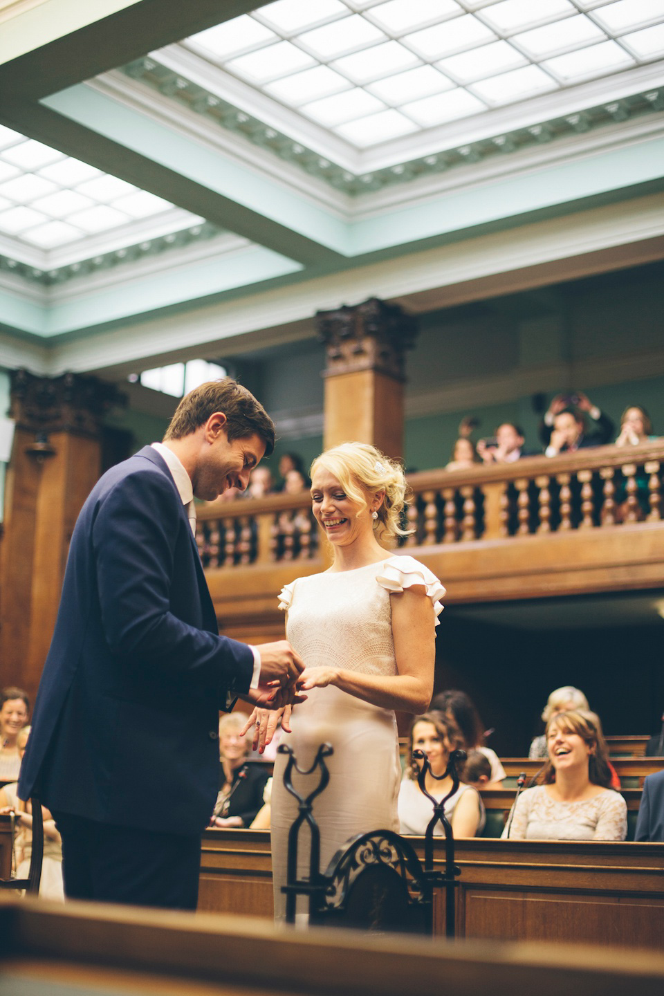 The bride wears a Belle & Bunty gown in blush for her child and family friendly wedding at Trinity Buoy Wharf in London. Photography by Kat Green.