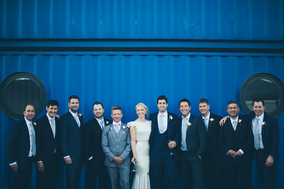 The bride wears a Belle & Bunty gown in blush for her child and family friendly wedding at Trinity Buoy Wharf in London. Photography by Kat Green.