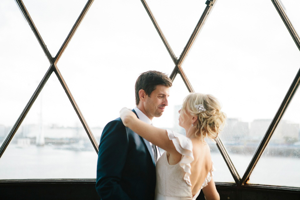 The bride wears a Belle & Bunty gown in blush for her child and family friendly wedding at Trinity Buoy Wharf in London. Photography by Kat Green.