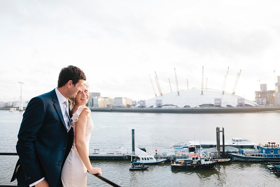 The bride wears a Belle & Bunty gown in blush for her child and family friendly wedding at Trinity Buoy Wharf in London. Photography by Kat Green.