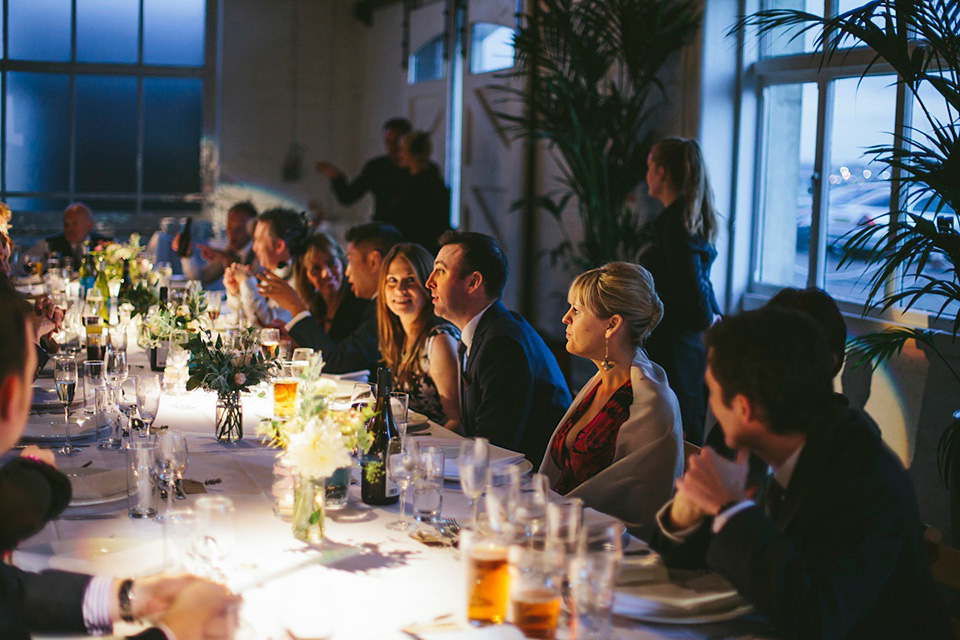 The bride wears a Belle & Bunty gown in blush for her child and family friendly wedding at Trinity Buoy Wharf in London. Photography by Kat Green.