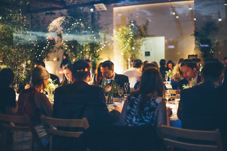 The bride wears a Belle & Bunty gown in blush for her child and family friendly wedding at Trinity Buoy Wharf in London. Photography by Kat Green.