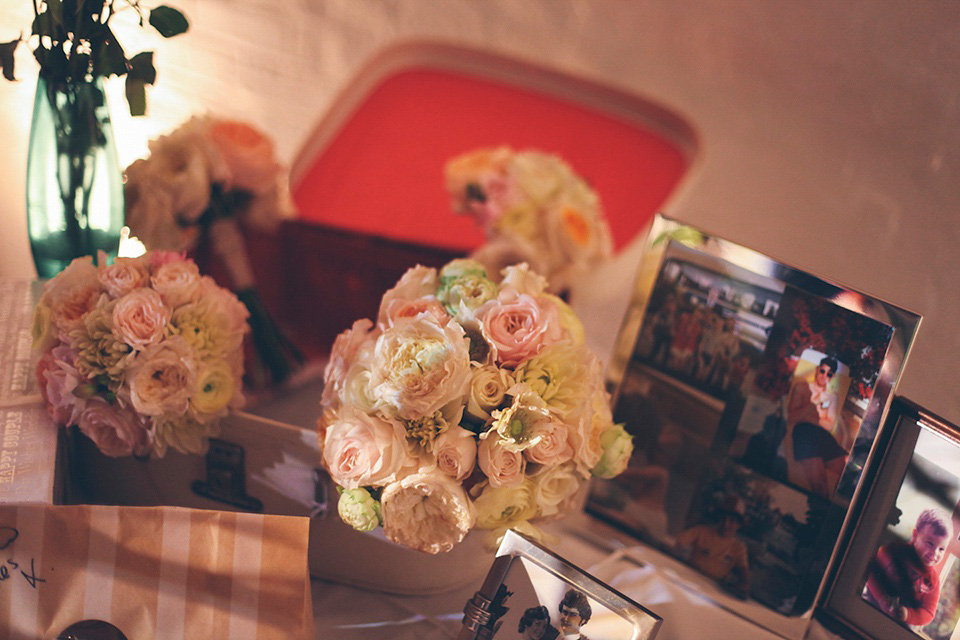 The bride wears a Belle & Bunty gown in blush for her child and family friendly wedding at Trinity Buoy Wharf in London. Photography by Kat Green.