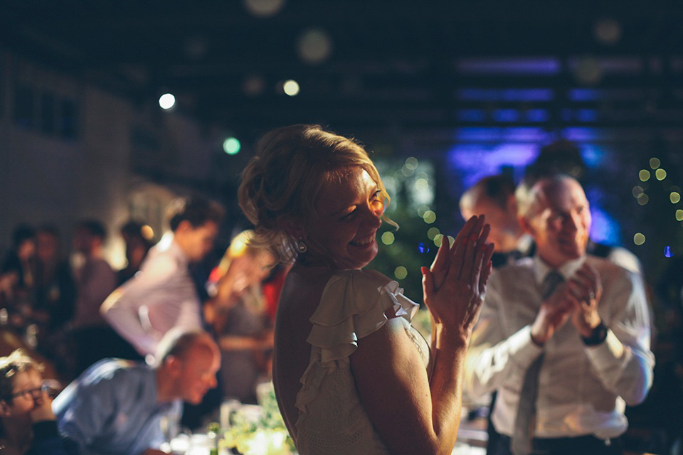 The bride wears a Belle & Bunty gown in blush for her child and family friendly wedding at Trinity Buoy Wharf in London. Photography by Kat Green.