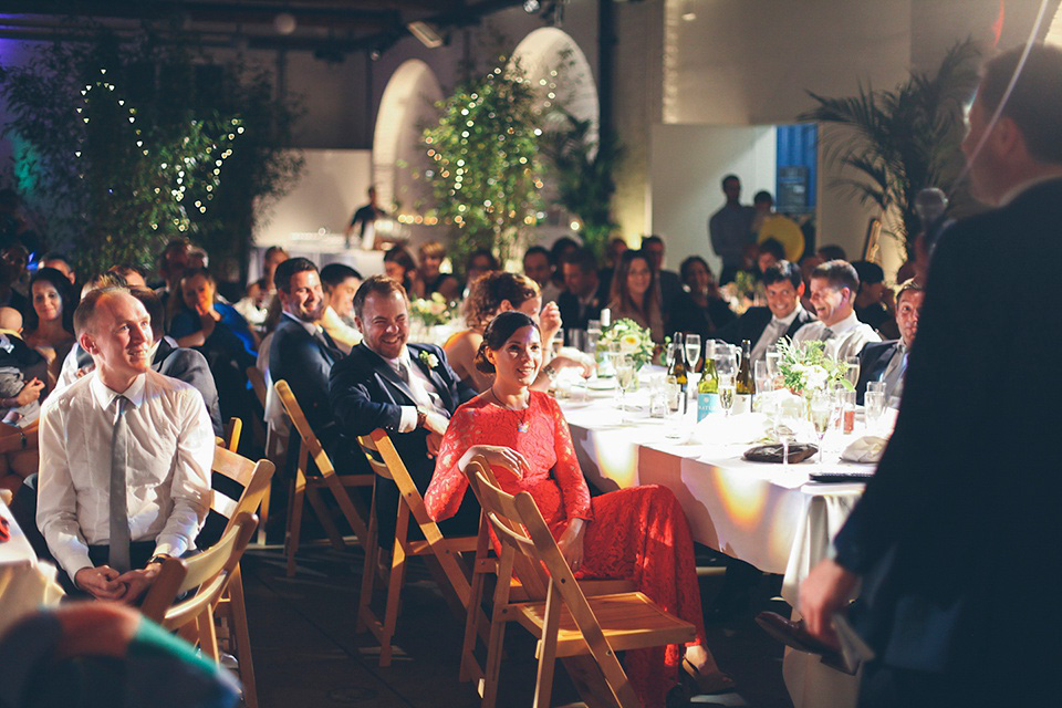 The bride wears a Belle & Bunty gown in blush for her child and family friendly wedding at Trinity Buoy Wharf in London. Photography by Kat Green.