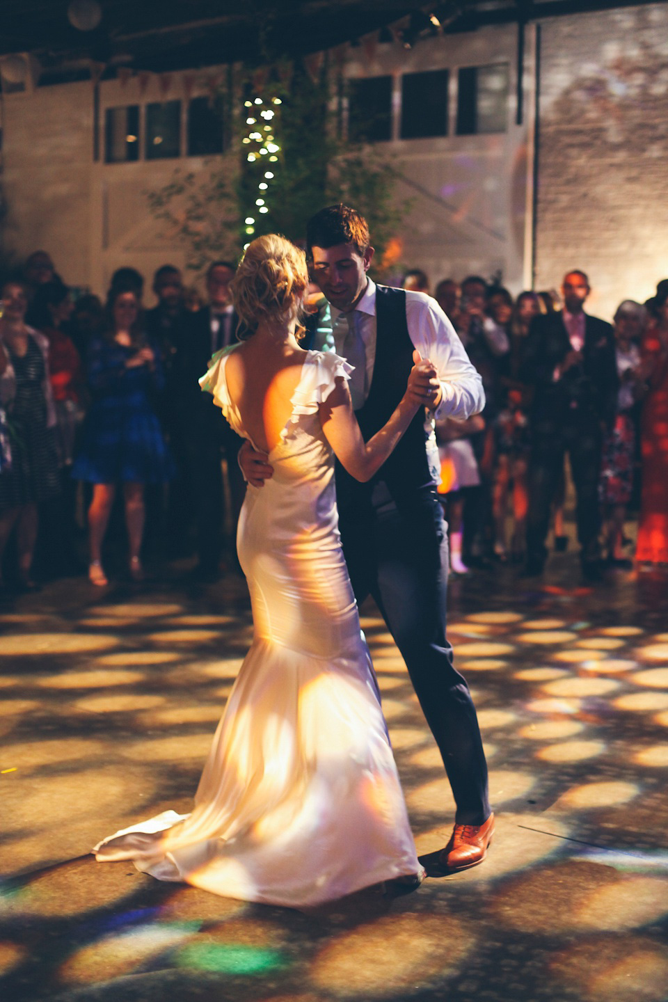 The bride wears a Belle & Bunty gown in blush for her child and family friendly wedding at Trinity Buoy Wharf in London. Photography by Kat Green.