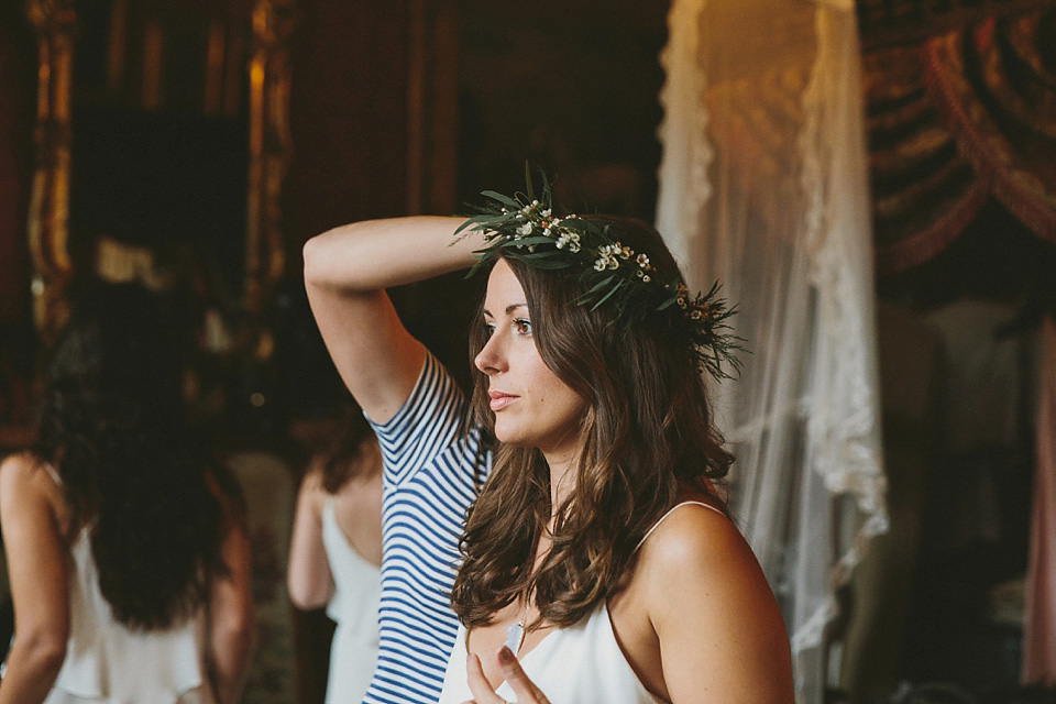 The bride wears a beautiful floral crown and Charlie Brear dress for her house party wedding at Maunsel House in Somerset. Photography by McKinley Rodgers.