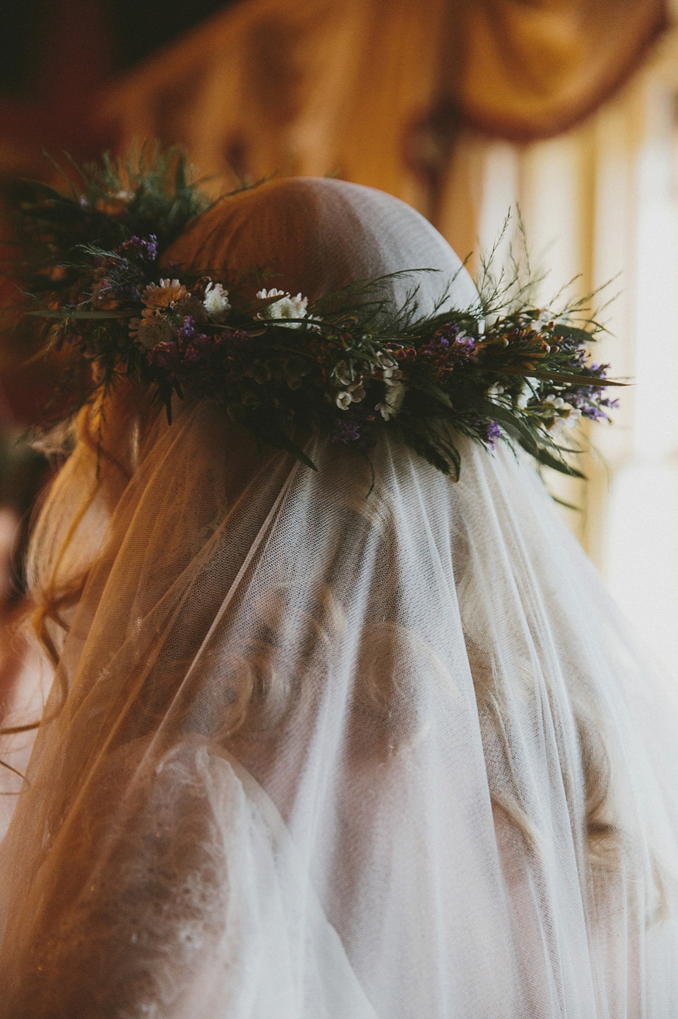 The bride wears a beautiful floral crown and Charlie Brear dress for her house party wedding at Maunsel House in Somerset. Photography by McKinley Rodgers.