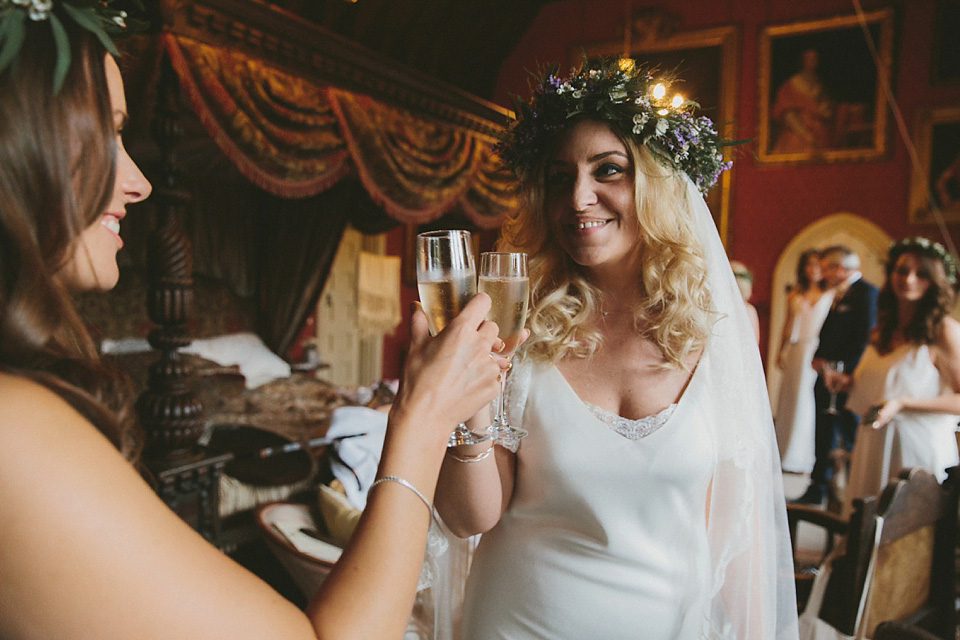 The bride wears a beautiful floral crown and Charlie Brear dress for her house party wedding at Maunsel House in Somerset. Photography by McKinley Rodgers.