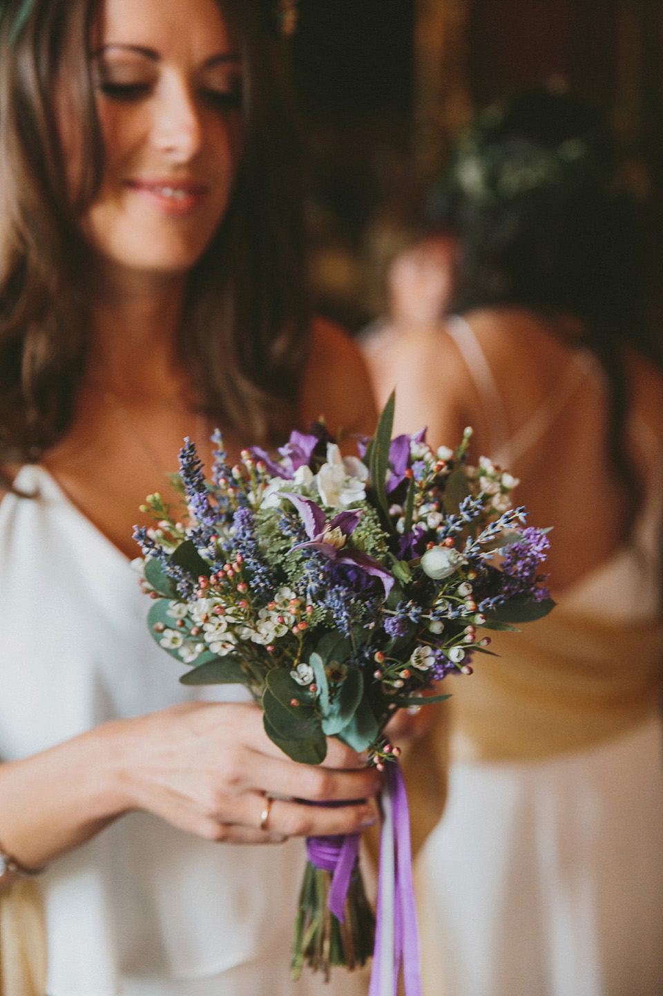 The bride wears a beautiful floral crown and Charlie Brear dress for her house party wedding at Maunsel House in Somerset. Photography by McKinley Rodgers.