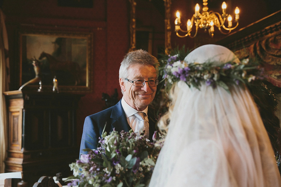 The bride wears a beautiful floral crown and Charlie Brear dress for her house party wedding at Maunsel House in Somerset. Photography by McKinley Rodgers.