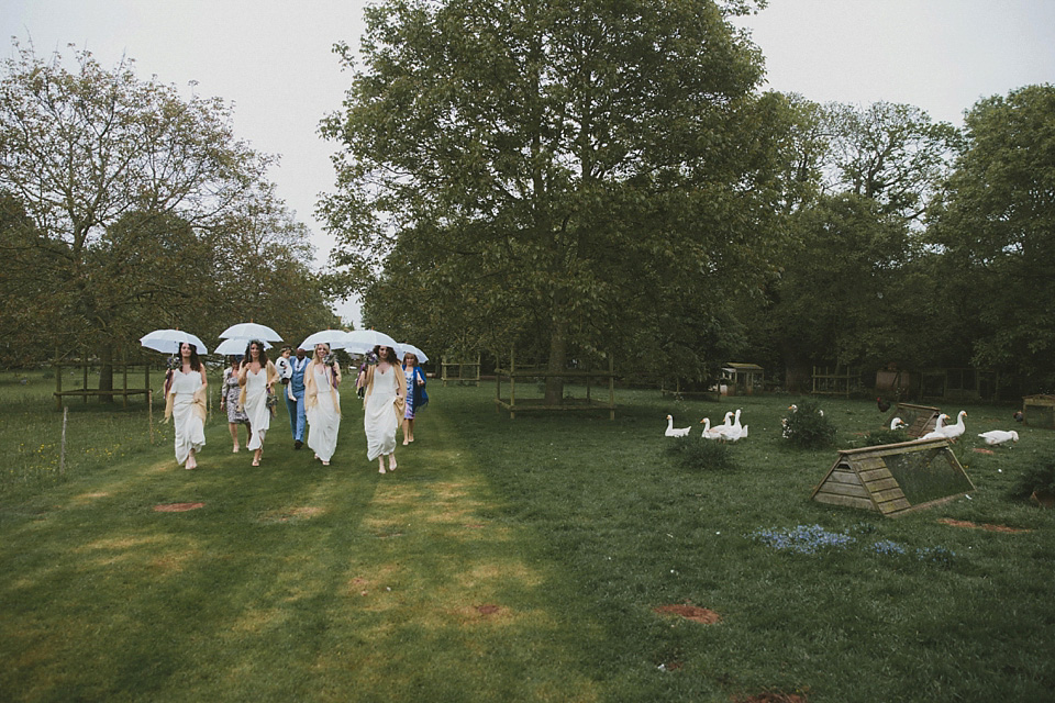 The bride wears a beautiful floral crown and Charlie Brear dress for her house party wedding at Maunsel House in Somerset. Photography by McKinley Rodgers.