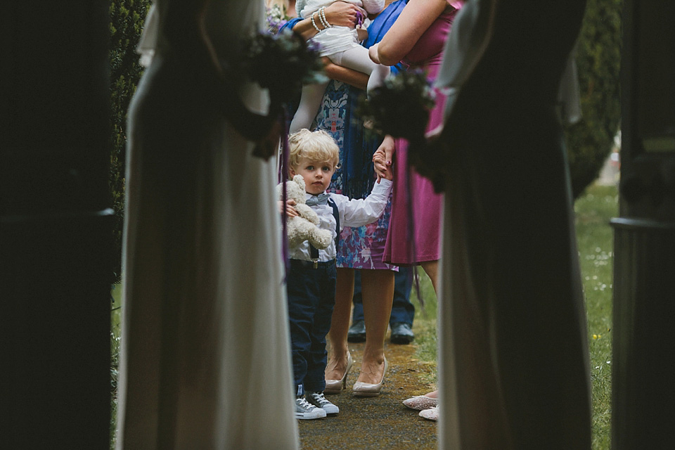 The bride wears a beautiful floral crown and Charlie Brear dress for her house party wedding at Maunsel House in Somerset. Photography by McKinley Rodgers.