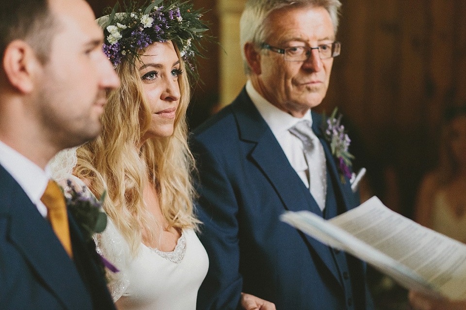 The bride wears a beautiful floral crown and Charlie Brear dress for her house party wedding at Maunsel House in Somerset. Photography by McKinley Rodgers.