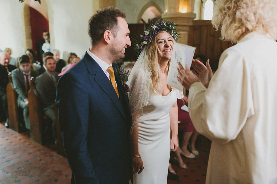 The bride wears a beautiful floral crown and Charlie Brear dress for her house party wedding at Maunsel House in Somerset. Photography by McKinley Rodgers.