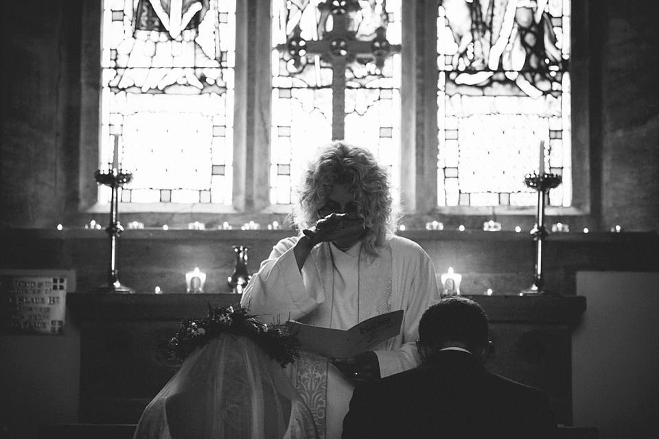 The bride wears a beautiful floral crown and Charlie Brear dress for her house party wedding at Maunsel House in Somerset. Photography by McKinley Rodgers.