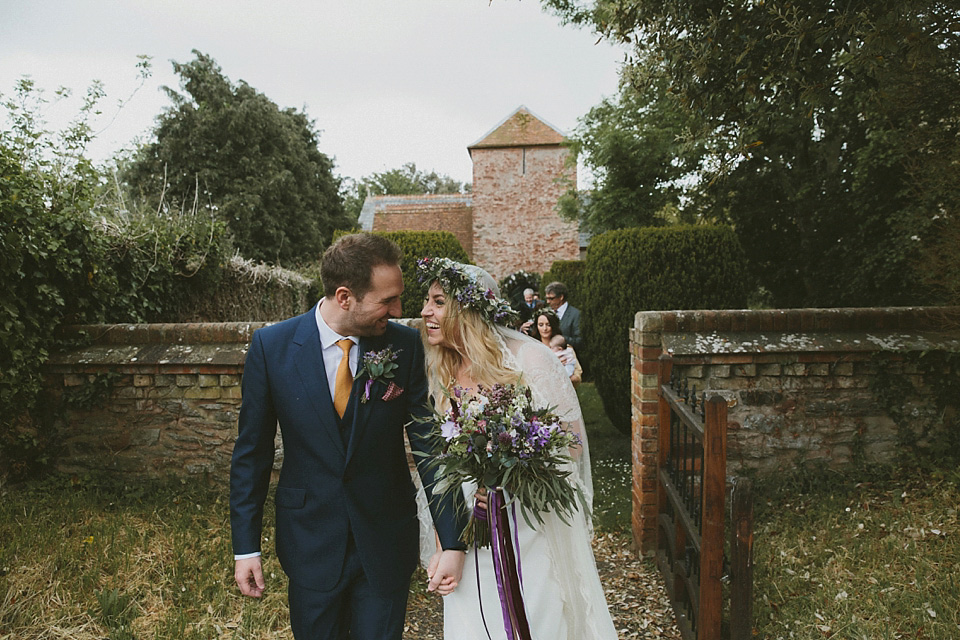 The bride wears a beautiful floral crown and Charlie Brear dress for her house party wedding at Maunsel House in Somerset. Photography by McKinley Rodgers.