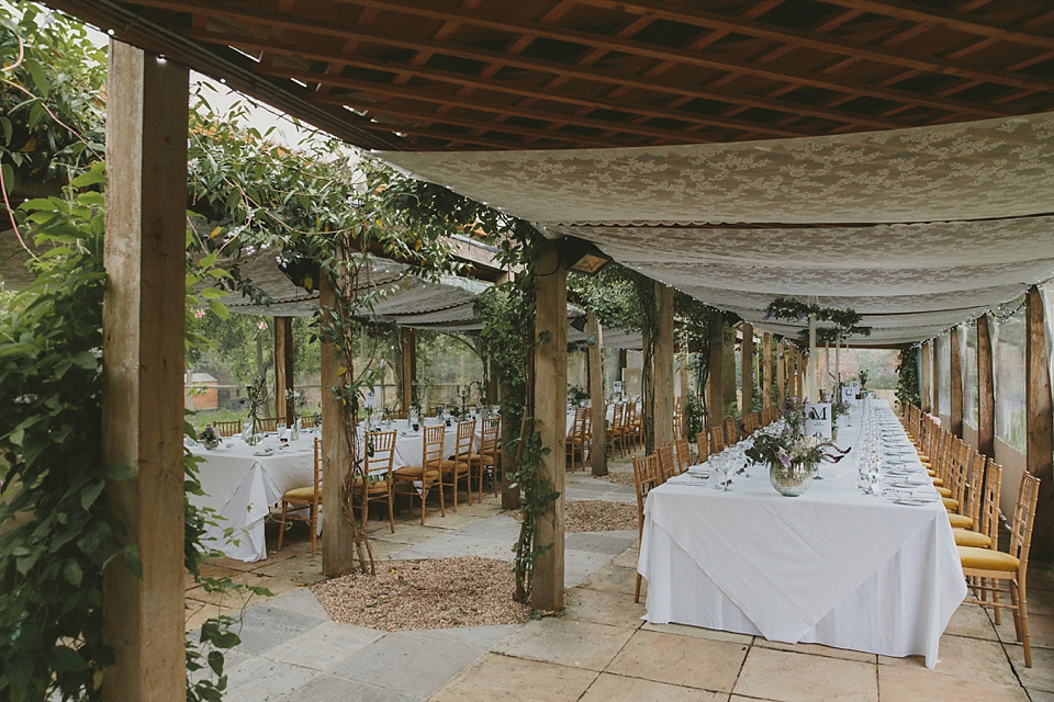 The bride wears a beautiful floral crown and Charlie Brear dress for her house party wedding at Maunsel House in Somerset. Photography by McKinley Rodgers.