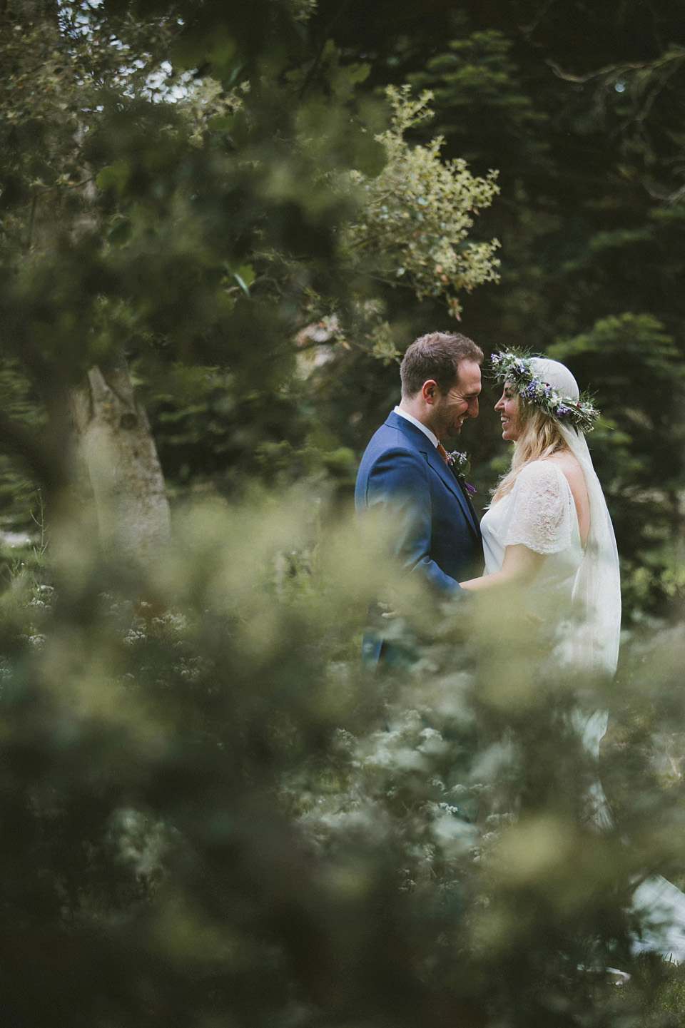 The bride wears a beautiful floral crown and Charlie Brear dress for her house party wedding at Maunsel House in Somerset. Photography by McKinley Rodgers.