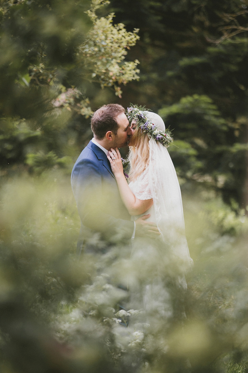 The bride wears a beautiful floral crown and Charlie Brear dress for her house party wedding at Maunsel House in Somerset. Photography by McKinley Rodgers.