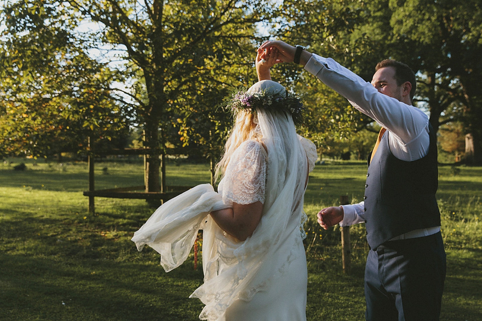 The bride wears a beautiful floral crown and Charlie Brear dress for her house party wedding at Maunsel House in Somerset. Photography by McKinley Rodgers.