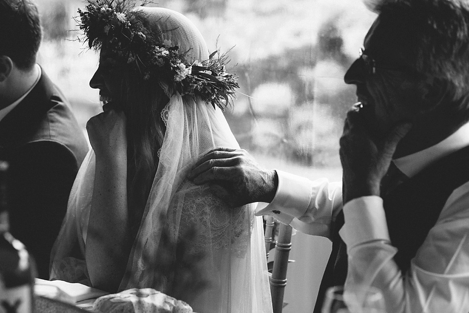 The bride wears a beautiful floral crown and Charlie Brear dress for her house party wedding at Maunsel House in Somerset. Photography by McKinley Rodgers.