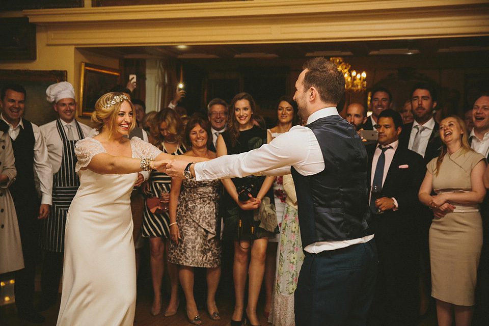 The bride wears a beautiful floral crown and Charlie Brear dress for her house party wedding at Maunsel House in Somerset. Photography by McKinley Rodgers.