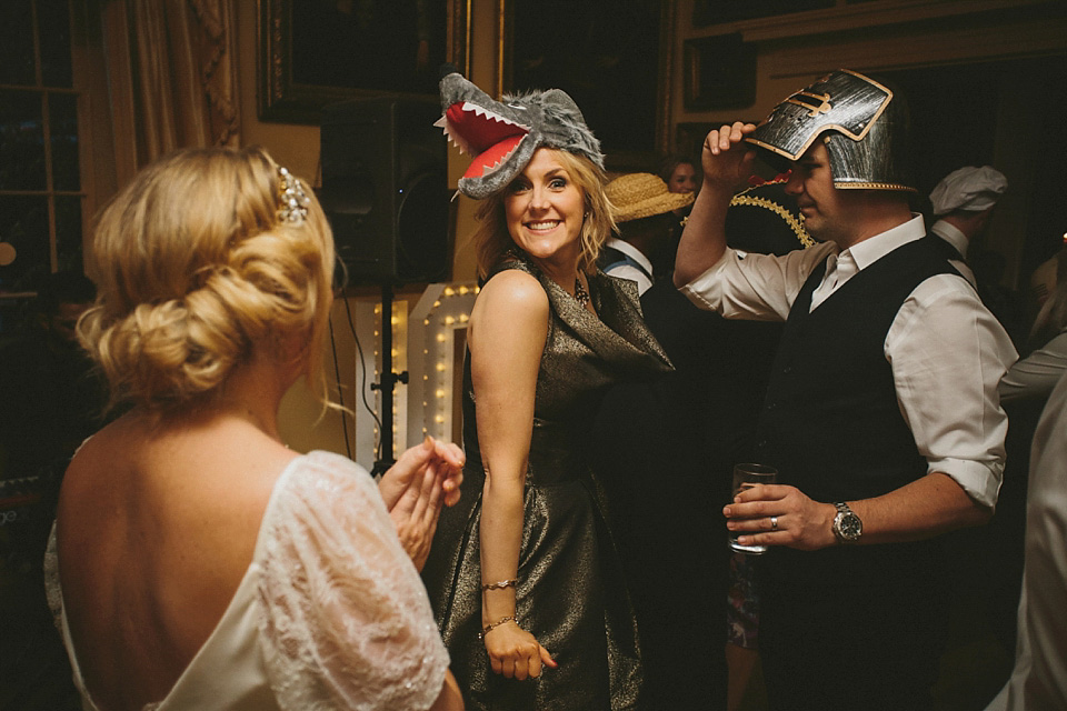 The bride wears a beautiful floral crown and Charlie Brear dress for her house party wedding at Maunsel House in Somerset. Photography by McKinley Rodgers.