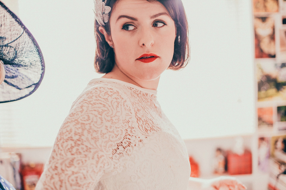 The bride wears green wedding shoes and a 50's style dress from Flossy and Dossy for her Glasgow wedding. Photography by John Elphinstone-Stirling.