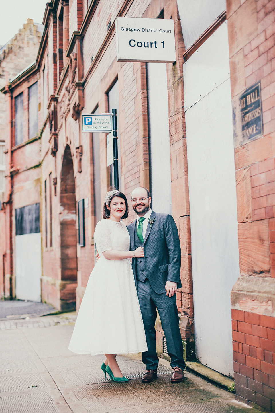 The bride wears green wedding shoes and a 50's style dress from Flossy and Dossy for her Glasgow wedding. Photography by John Elphinstone-Stirling.