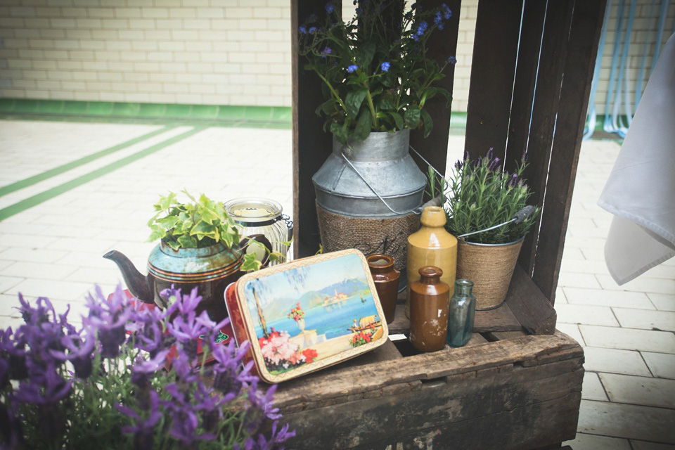 The bride wears a Charlotte Balbier gown for her 50's vintage inspired pale blue wedding at Victoria Baths, Manchester.