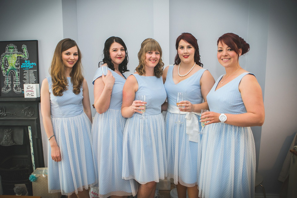 The bride wears a Charlotte Balbier gown for her 50's vintage inspired pale blue wedding at Victoria Baths, Manchester.