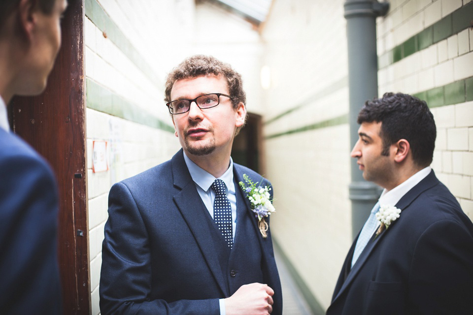 The bride wears a Charlotte Balbier gown for her 50's vintage inspired pale blue wedding at Victoria Baths, Manchester.