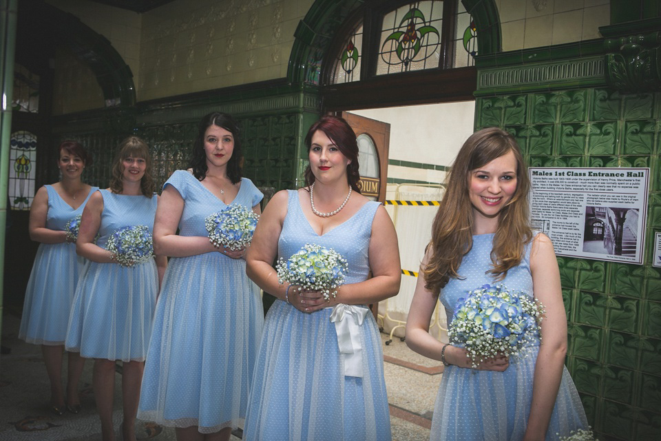 The bride wears a Charlotte Balbier gown for her 50's vintage inspired pale blue wedding at Victoria Baths, Manchester.