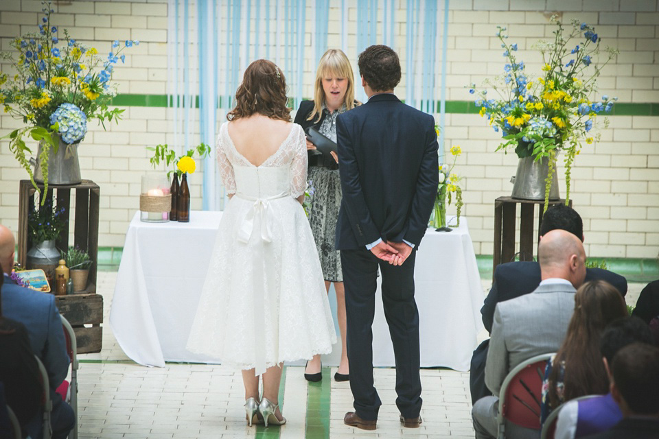 The bride wears a Charlotte Balbier gown for her 50's vintage inspired pale blue wedding at Victoria Baths, Manchester.