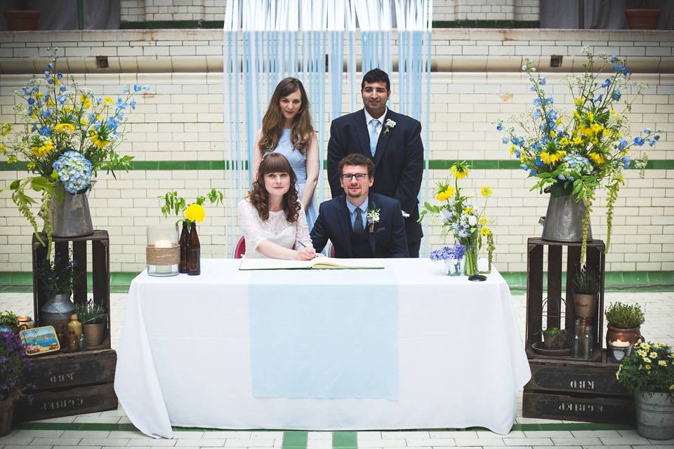 The bride wears a Charlotte Balbier gown for her 50's vintage inspired pale blue wedding at Victoria Baths, Manchester.