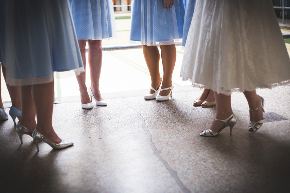 The bride wears a Charlotte Balbier gown for her 50's vintage inspired pale blue wedding at Victoria Baths, Manchester.