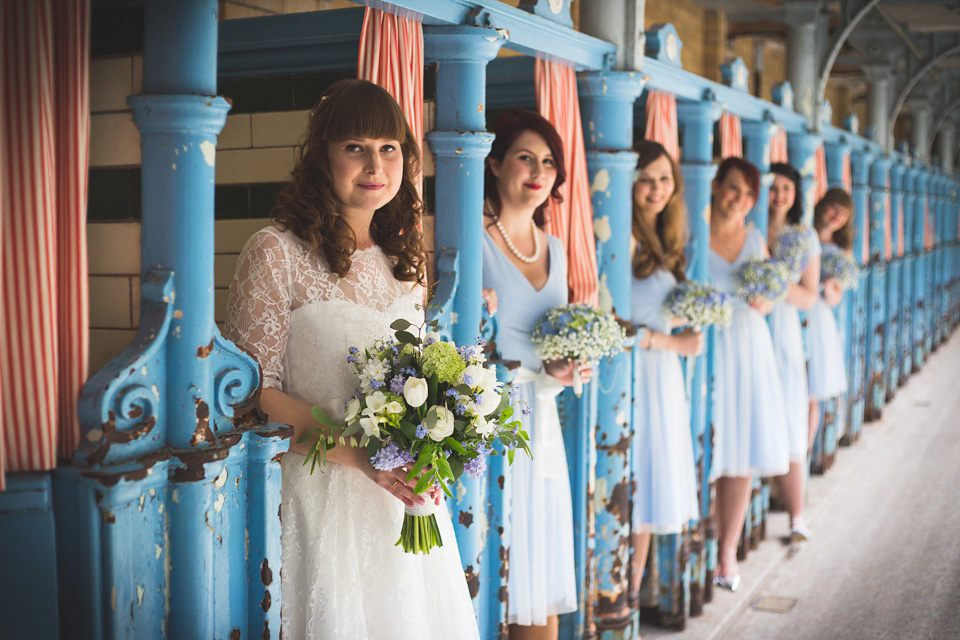 The bride wears a Charlotte Balbier gown for her 50's vintage inspired pale blue wedding at Victoria Baths, Manchester.