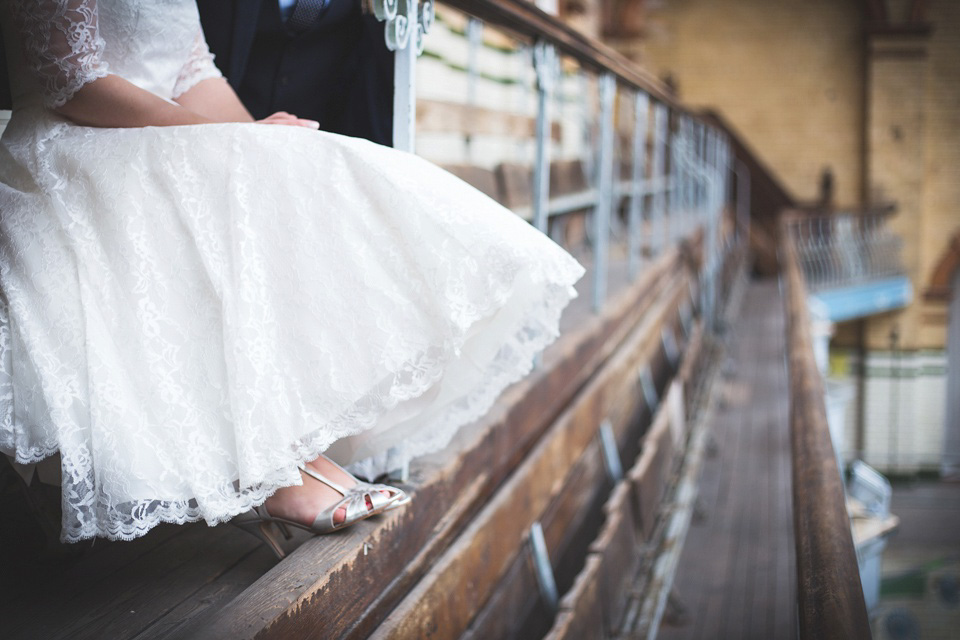 The bride wears a Charlotte Balbier gown for her 50's vintage inspired pale blue wedding at Victoria Baths, Manchester.