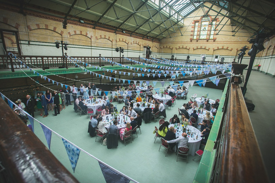 The bride wears a Charlotte Balbier gown for her 50's vintage inspired pale blue wedding at Victoria Baths, Manchester.