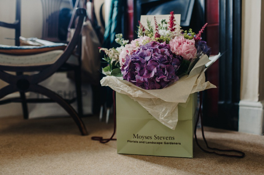 Bride Jess wears an original 1970's vintage Ossie Clarke dress for her Jewish wedding ceremony at Home House in London. Photography by Rebecca Goddard.