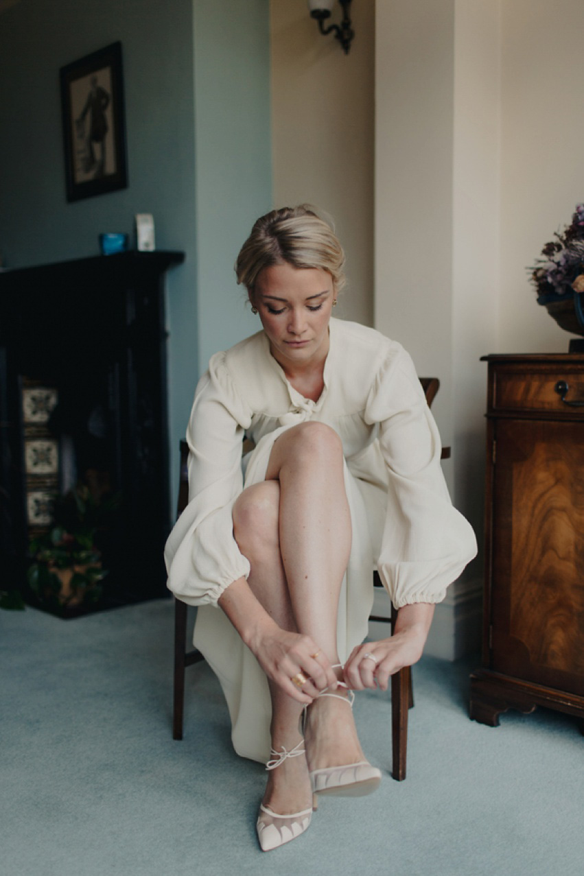 Bride Jess wears an original 1970's vintage Ossie Clarke dress for her Jewish wedding ceremony at Home House in London. Photography by Rebecca Goddard.