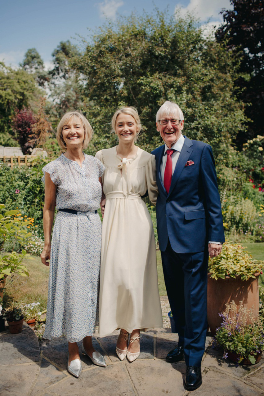 Bride Jess wears an original 1970's vintage Ossie Clarke dress for her Jewish wedding ceremony at Home House in London. Photography by Rebecca Goddard.