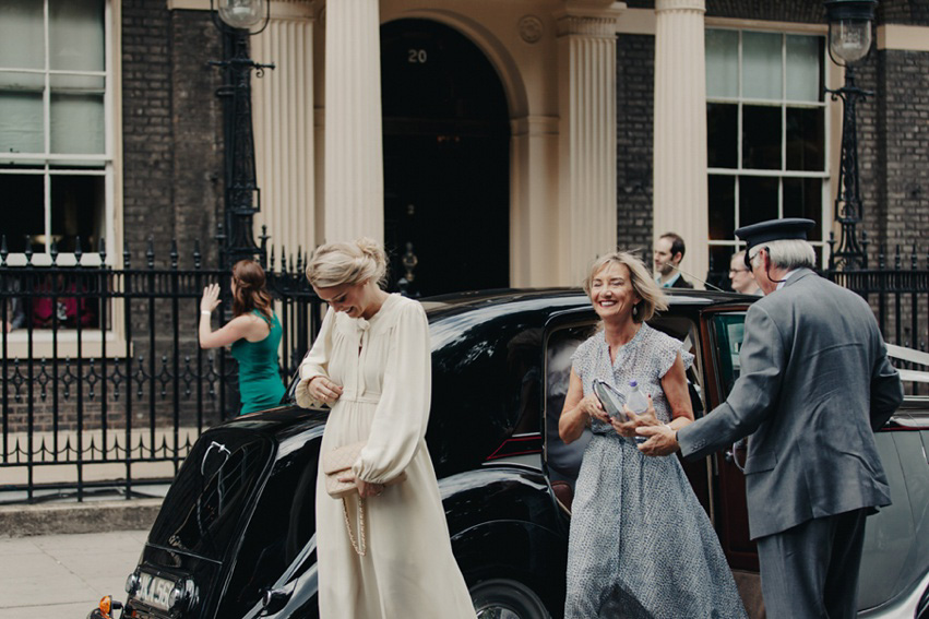 Bride Jess wears an original 1970's vintage Ossie Clarke dress for her Jewish wedding ceremony at Home House in London. Photography by Rebecca Goddard.