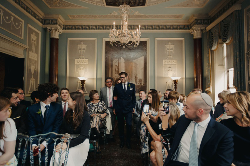 Bride Jess wears an original 1970's vintage Ossie Clarke dress for her Jewish wedding ceremony at Home House in London. Photography by Rebecca Goddard.