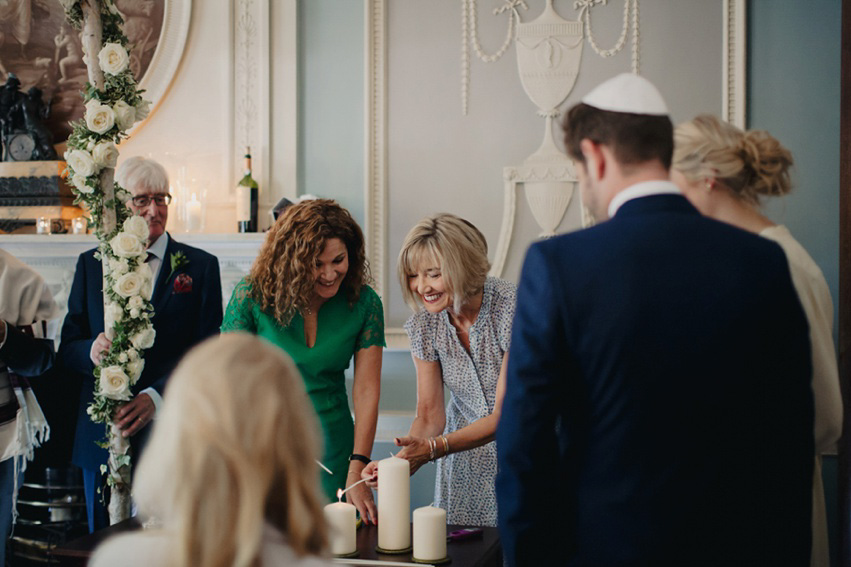 Bride Jess wears an original 1970's vintage Ossie Clarke dress for her Jewish wedding ceremony at Home House in London. Photography by Rebecca Goddard.